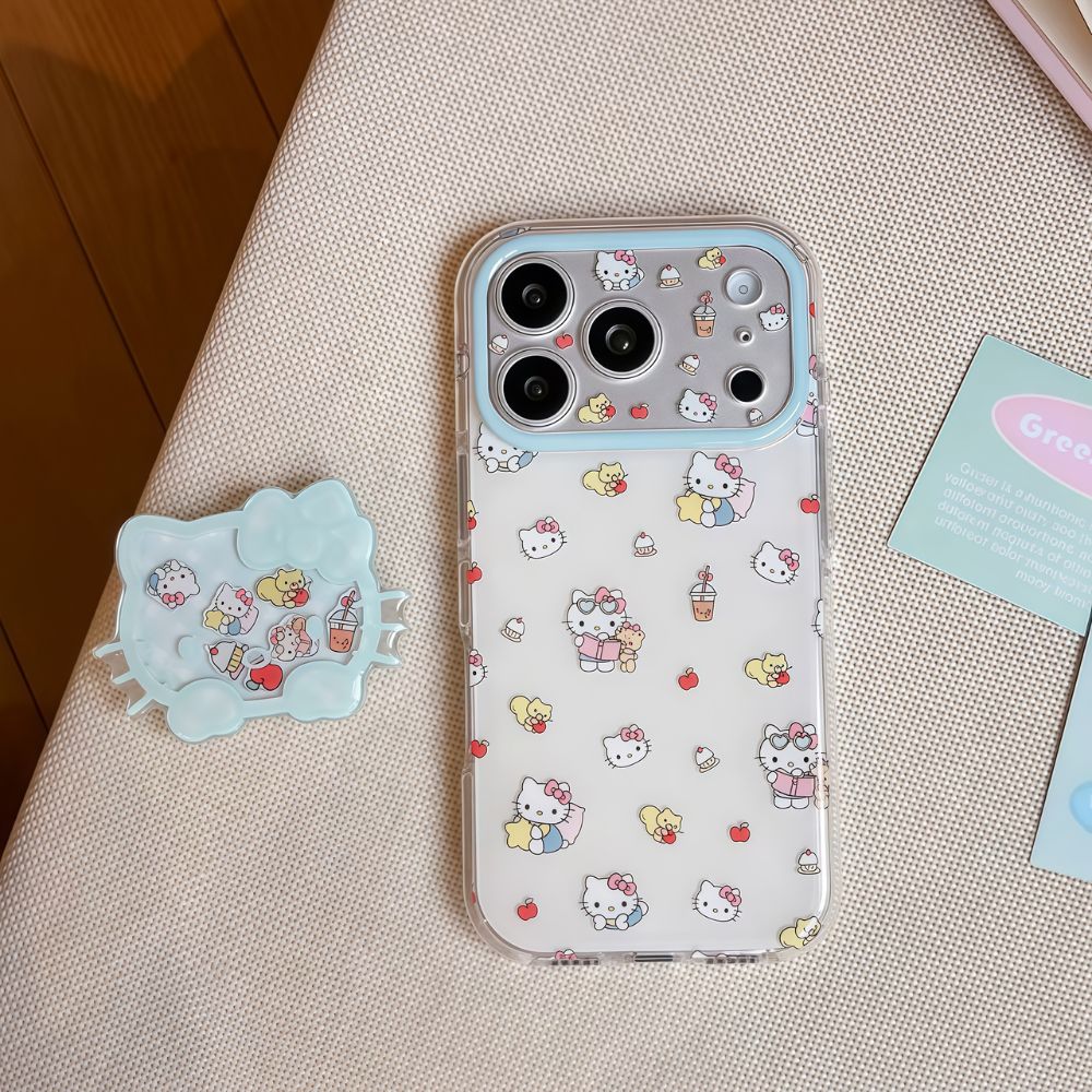 A clear iPhone case with a light blue camera bezel, decorated with a Hello Kitty and Tiny Chum pattern. Next to the phone is a matching light blue Hello Kitty-shaped liquid glitter shaker grip, both resting on a beige textured surface.